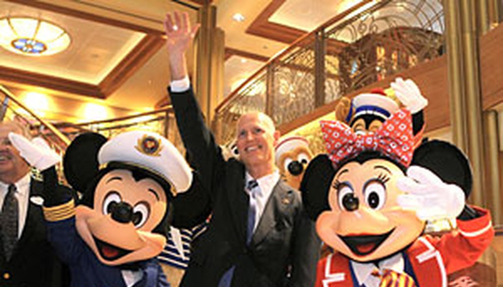 Rick Scott waves with Mickey and Minnie Mouse during a welcoming ceremony his first week in office aboard the new $900 million Disney Dream cruise ship in Port Canaveral.