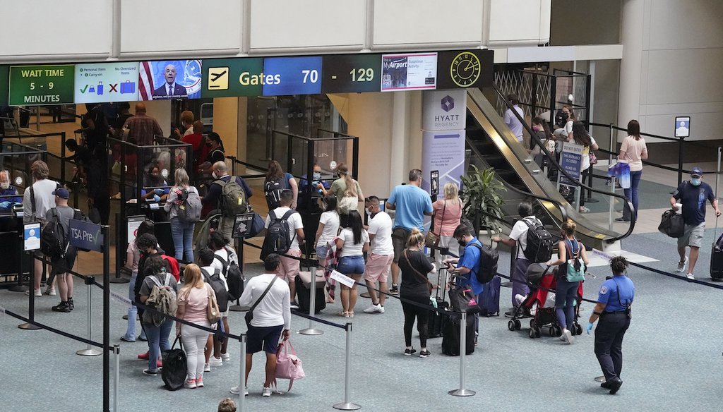 Travelers line up to go through a TSA checkpoint at Orlando International Airport on May 28, 2021. (AP)