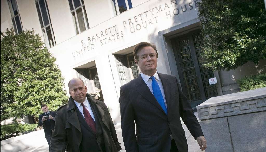 Former Donald Trump campaign manager Paul Manafort, right, leaves U.S. District Court in Washington after pleading not guilty to charges stemming from Robert Mueller's investigation into Russia's meddling in the 2016 elelction. (Getty Images photo)