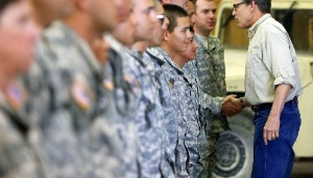 Gov. Rick Perry shakes hands with National Guard troops training at Camp Swift in Bastrop, Texas Aug. 13, 2014 before they deployed to the Texas-Mexico border region (Associated Press photo).
