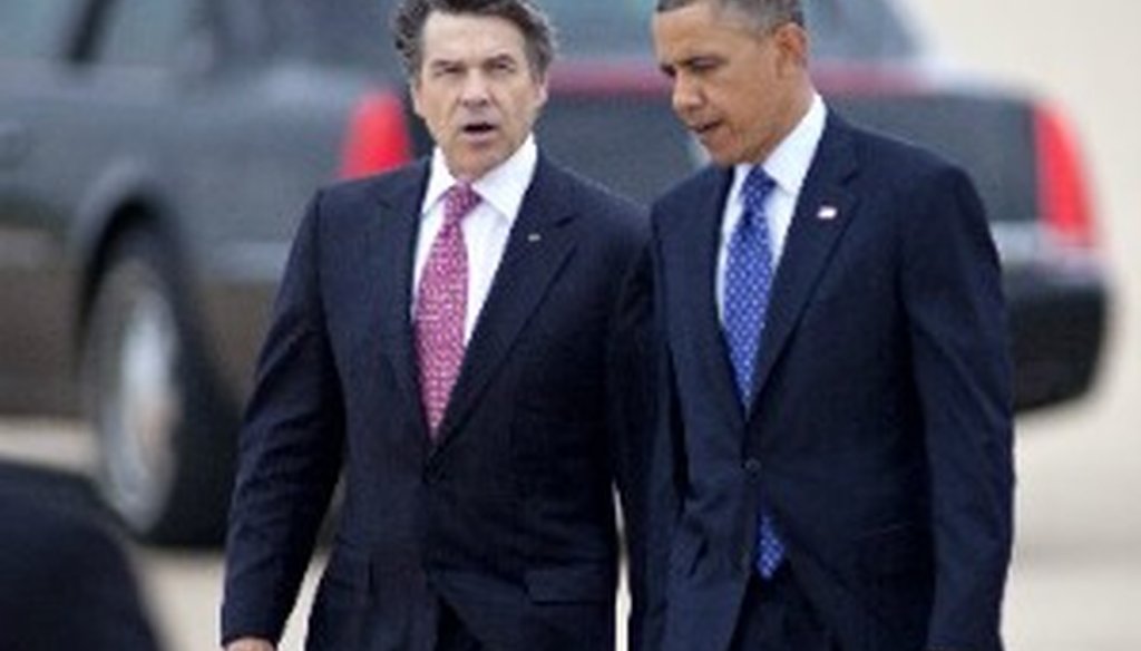 Gov. Rick Perry talks with President Barack Obama as they walk to greet spectators at Austin Bergstrom International Airport, Thursday, May 9, 2013. (AP Photo/Marisa Vasquez, The Daily Texan)