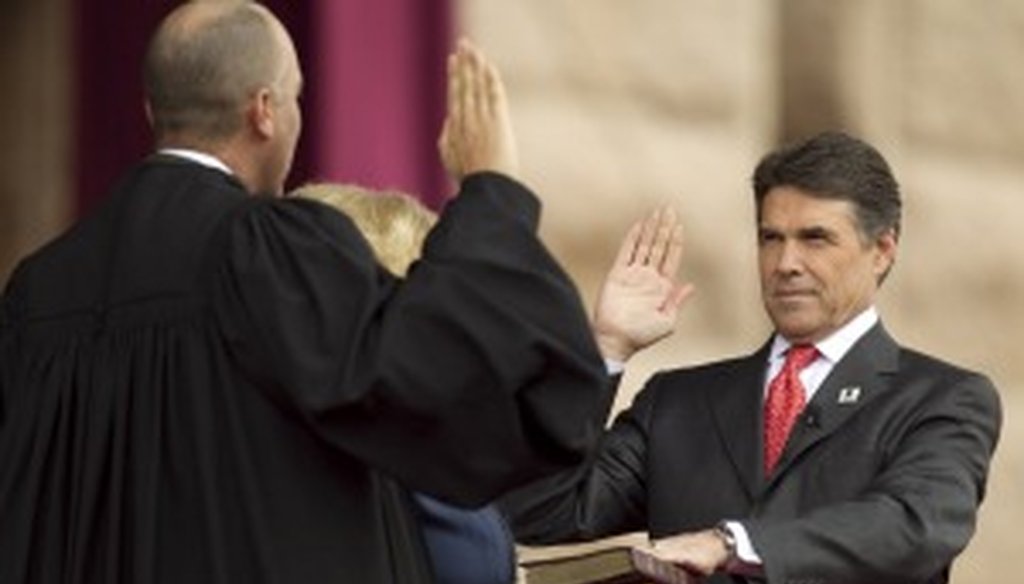Gov. Rick Perry taking the oath of office during his inauguration. We solemnly swear we will track his campaign promises.