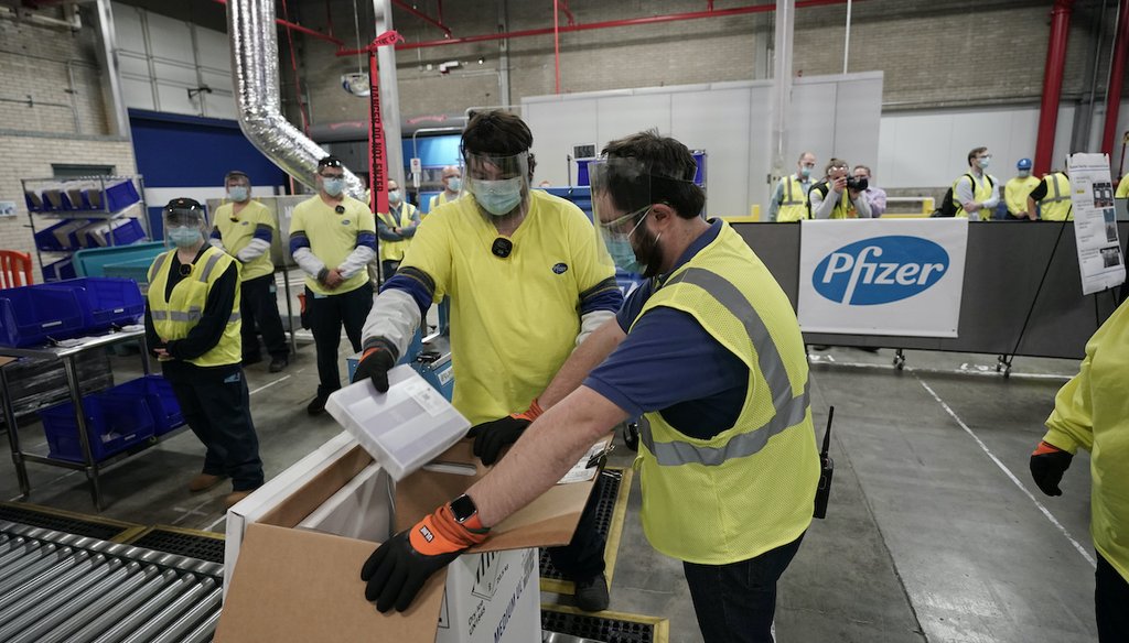 Workers prepare boxes of the Pfizer-BioNTech COVID-19 vaccine for shipment at a Michigan factory, Dec. 13, 2020. (AP)