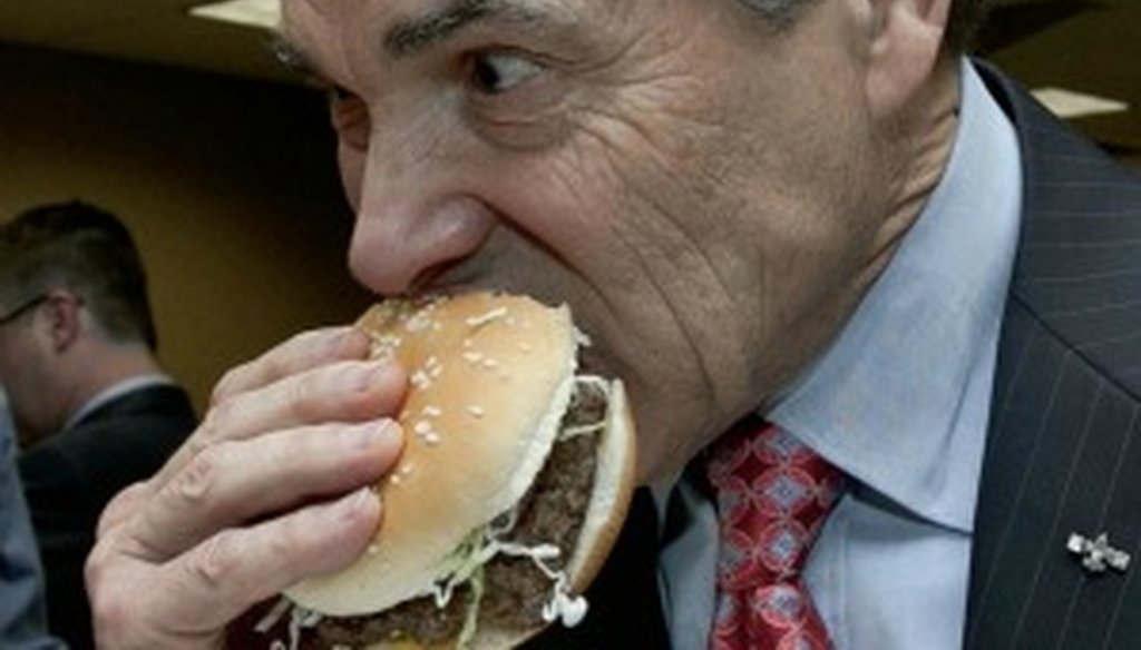Texas Gov. Rick Perry tasted a hamburger containing lean, finely textured beef — called pink slime by critics — after a March 29, 2012, tour of a Sioux City, Neb., plant where the meat product is made. (Source: Associated Press)