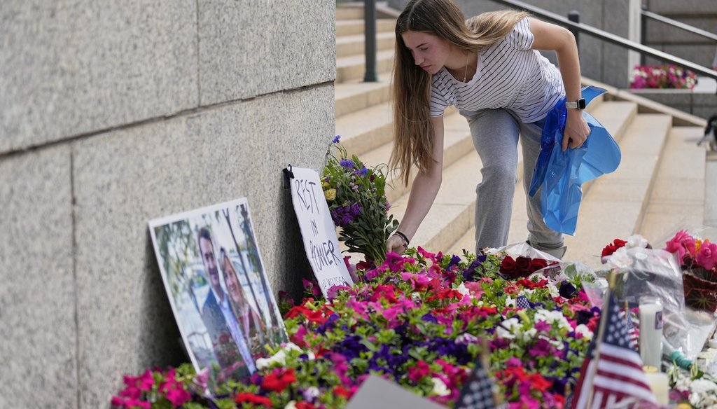 Claire Stein places flowers at a makeshift memorial for Minnesota state Rep. Melissa Hortman and her husband Mark at the state Capitol, June 15, 2025, in St. Paul, Minn. (AP)
