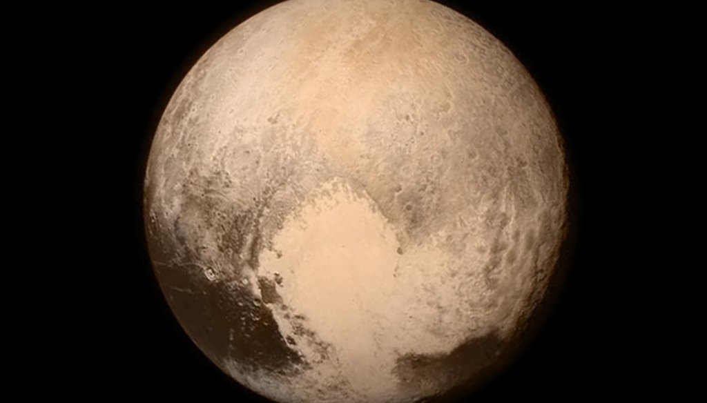 This image sent July 13, 2015, from the New Horizons spacecraft shows the best-ever view of Pluto. A few days later, scientists said the dwarf planet has large frozen plains in its heart-shaped area, which is next to rugged mountains of water ice. (NASA) 