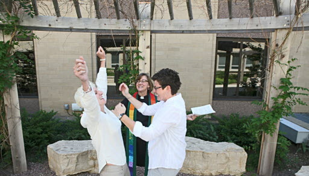  Rev. Suzelle Lynch of Unitarian Universalist Church West in Brookfield marries Karen Wells (right) and Kristie Erickson (left) of Waukesha, in a ceremony in the courtyard outside the Waukesha County Courthouse on June 9, 2014. JS photo/Mike Sears