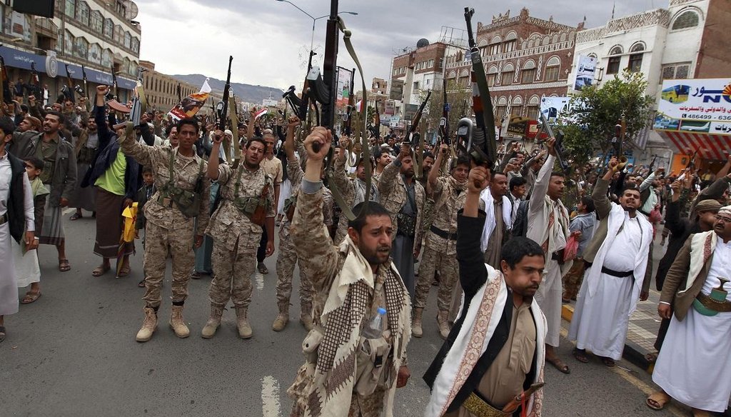 Shiite rebels, known as Houthis, hold up their weapons to protest against Saudi-led airstrikes, as they chant slogans during a rally in Sanaa, Yemen, on March 26, 2015. (AP Photo)