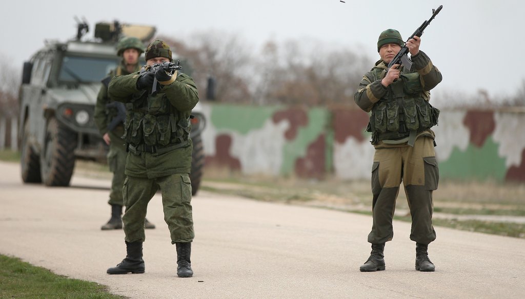 Troops under Russian command and in unmarked uniforms fired their weapons into the air on March 4 to warn Ukrainian troops to turn back at the Russian-occupied Belbek airbase in Crimea (Getty Images).