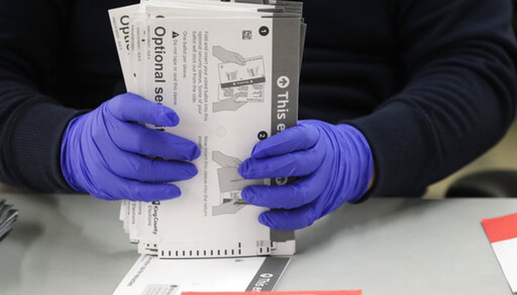 A worker wears gloves while handling ballots from the Washington state primary election, Tuesday, March 10, 2020, at the King County Elections headquarters in Renton, Wash. (AP)