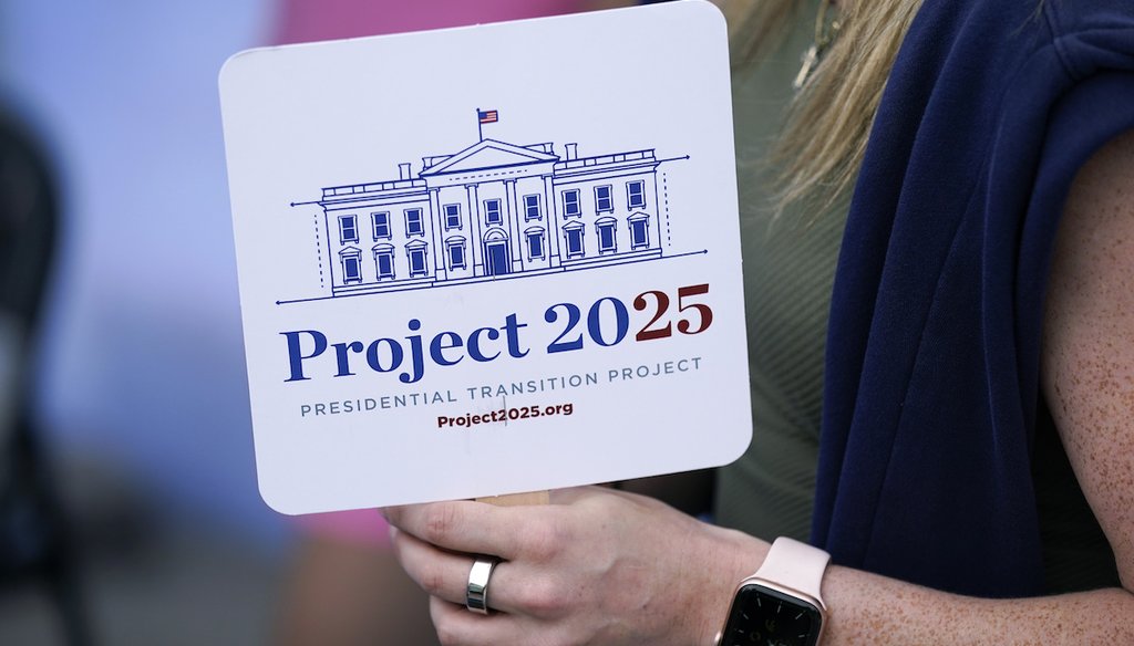 Kristen Eichamer, right, talks to a fairgoer at the Project 2025 tent at the Iowa State Fair, Aug. 14, 2023, in Des Moines, Iowa. (AP)