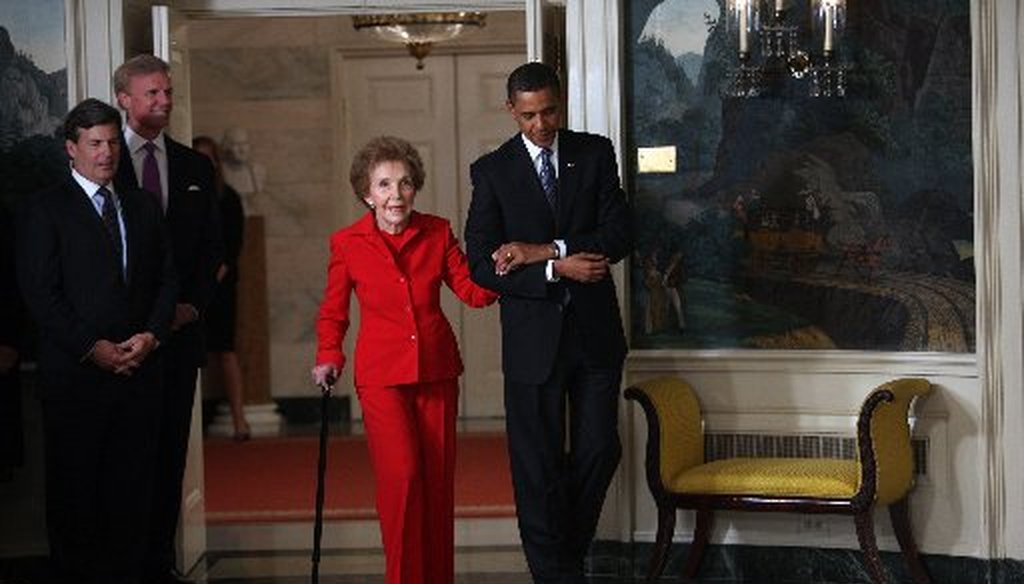 Former first lady Nancy Reagan is escorted by President Barack Obama to the signing of the Ronald Reagan Centennial Commission Act at the White House on June 2, 2009 (New York Times photo).