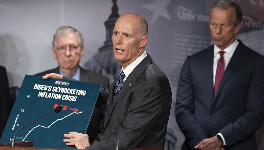 Sen. Rick Scott with Senate Minority Leader Mitch McConnell of Ky., left, and Sen. John Thune, R-S.D., holds up a graph as he speaks during a news conference following the Republican policy luncheon, July 12, 2022, in Washington. (AP)