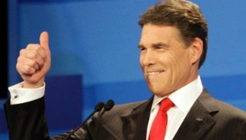 Rick Perry greets the audience before the Dec. 15, 2011, GOP debate in Sioux City, Iowa (Associated Press photo).