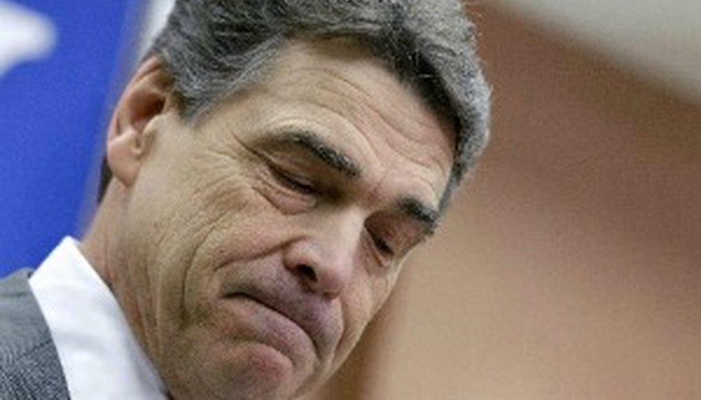 Rick Perry pauses as he suspends his campaign in South Carolina Jan. 19, 2012 (Associated Press photo, David Goldman.)