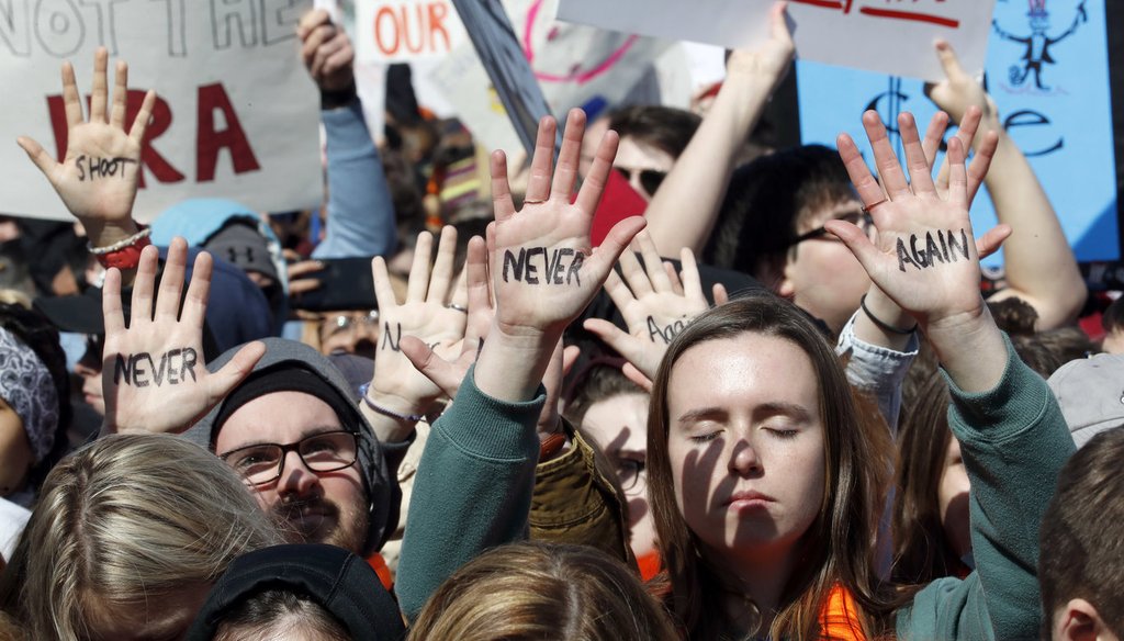 People hold their hands up with messages written on them during the March For Our Lives rally in support of gun control March 24, 2018, in Washington. (AP)