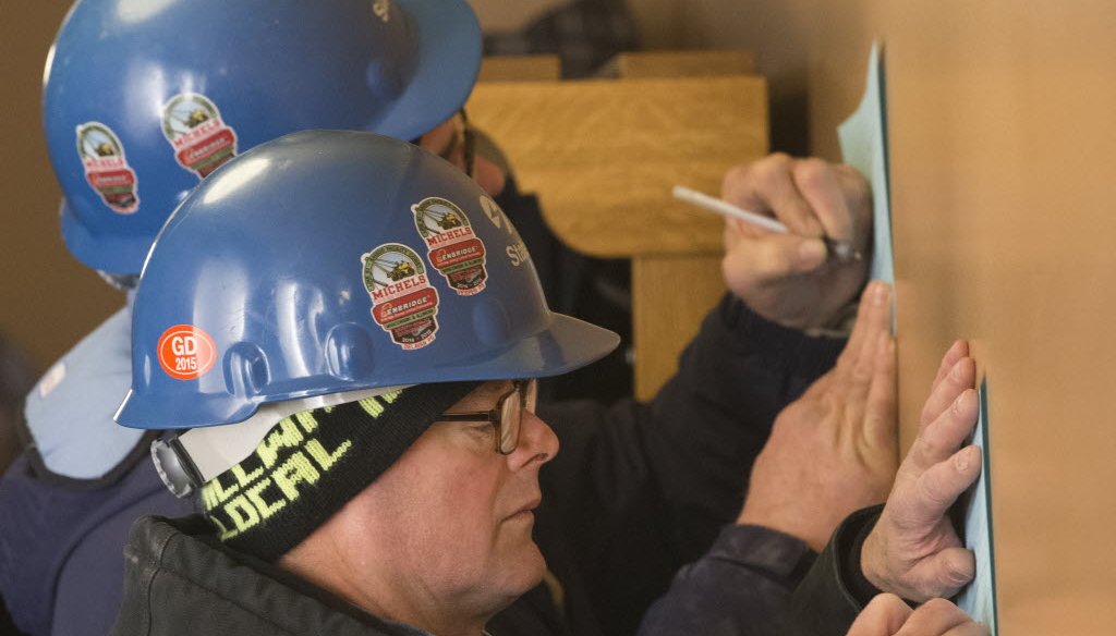 Rod Parrish, a union millwright, fills out a comment sheet in opposition to right to work legislation outside a senate labor committee hearing Tuesday, February 24, 2015 at the Capitol in Madison. JS photo