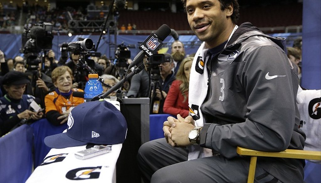 Seattle Seahawks quarterback Russell Wilson talks to members of the media.