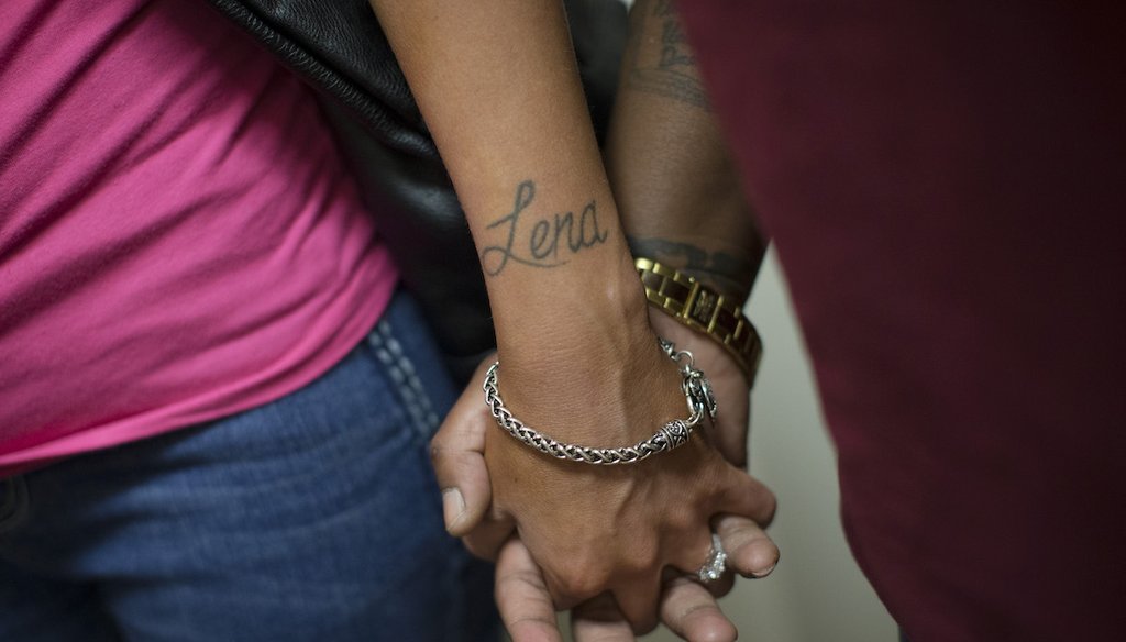 Crystal Zimmer, left, and her wife, Lena Williams, hold hands after being married, June 26, 2015 at Hamilton County Municipal Court in Cincinnati. (AP)