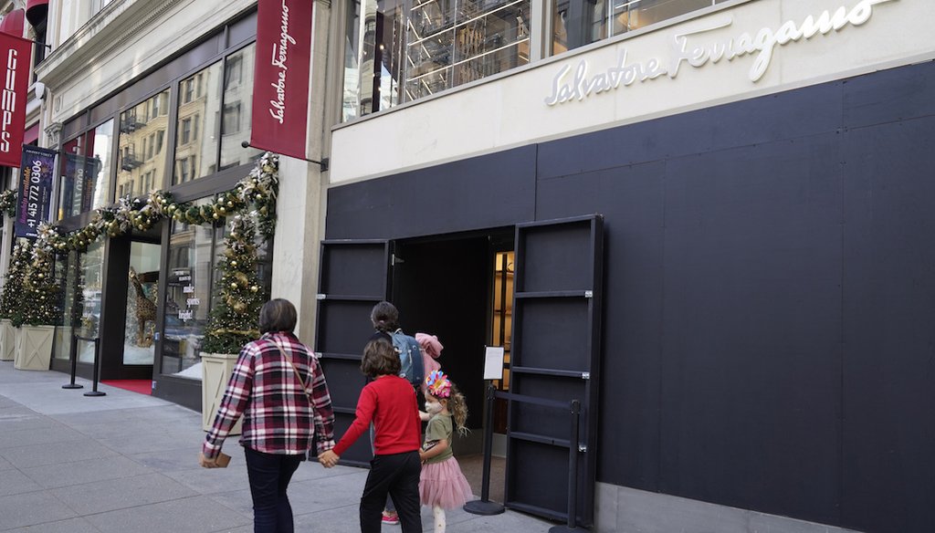 People walk past a boarded storefront window of a Salvatore Ferragamo store in 2021 following robberies in San Francisco's Union Square neighborhood. (AP)