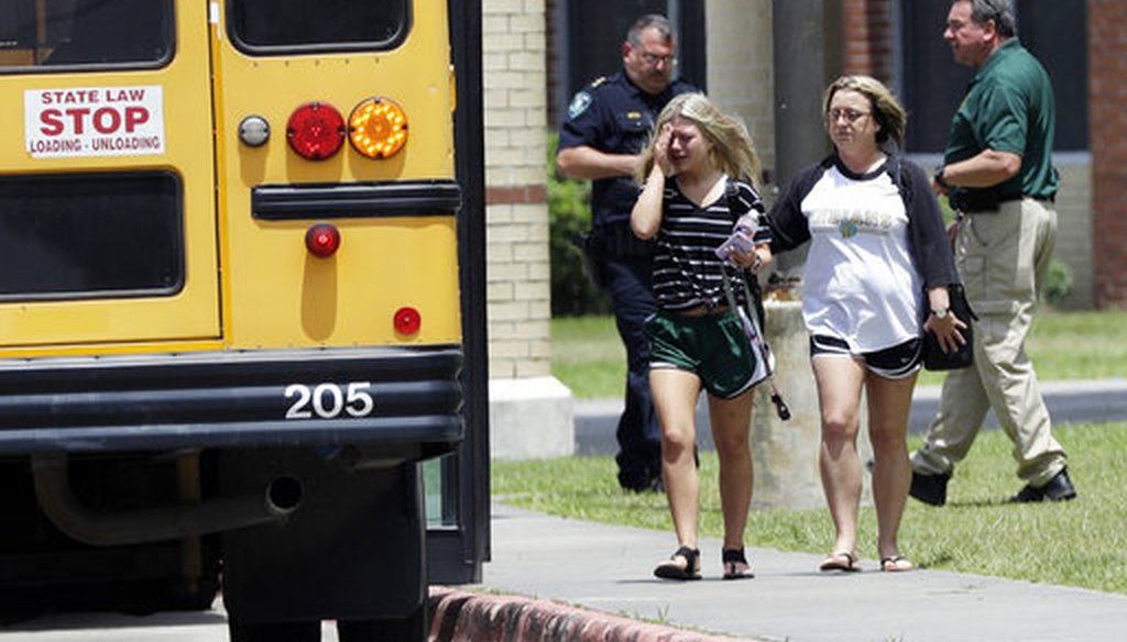 A student, left, reacts after retrieving her belongings inside Santa Fe High School in Santa Fe, Texas, on Saturday, May 19, 2018. Students and teachers were allowed to return to parts of the school to gather their belongings. (AP)