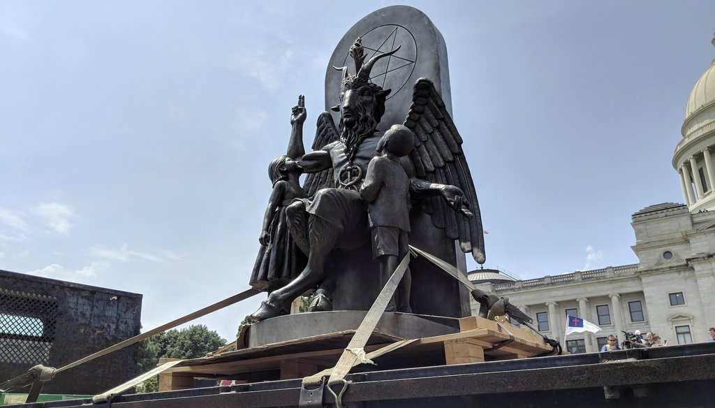 The Satanic Temple unveils its statue of Baphomet, a winged-goat creature, at a First Amendment rally in Little Rock, Ark., on Aug. 16, 2018. (AP Photo/Hannah Grabenstein)