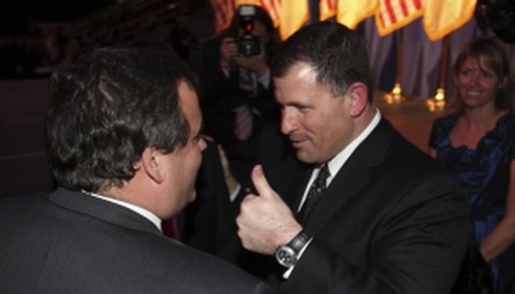 Gov. Chris Christie talks with former Rutgers University football coach Greg Schiano in 2010.