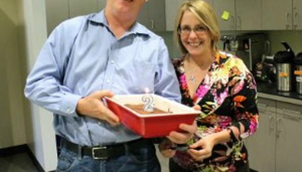The Austin American-Statesman's W. Gardner Selby presents second-anniversary brownies to Emily Donahue, news director of Austin's KUT News, 90.5 FM (KUT News photo).