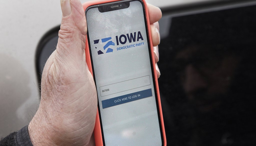 Precinct captain Carl Voss of Des Moines displays the Iowa Democratic Party caucus reporting app on his phone outside of the Iowa Democratic Party headquarters in Des Moines, Iowa, Tuesday, Feb. 4, 2020. (AP Photo/Nati Harnik)