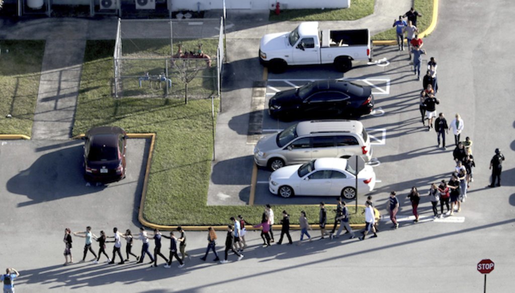 Students are evacuated by police from Marjorie Stoneman Douglas High School in Parkland, Fla., on Wednesday, Feb. 14, 2018, after a shooter opened fire on the campus. (Mike Stocker | South Florida Sun-Sentinel via AP)