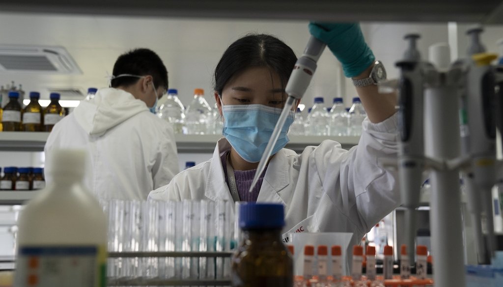 An SinoVac employee works in a lab at a factory producing its SARS CoV-2 vaccine in Beijing on Sept. 24, 2020. (AP)