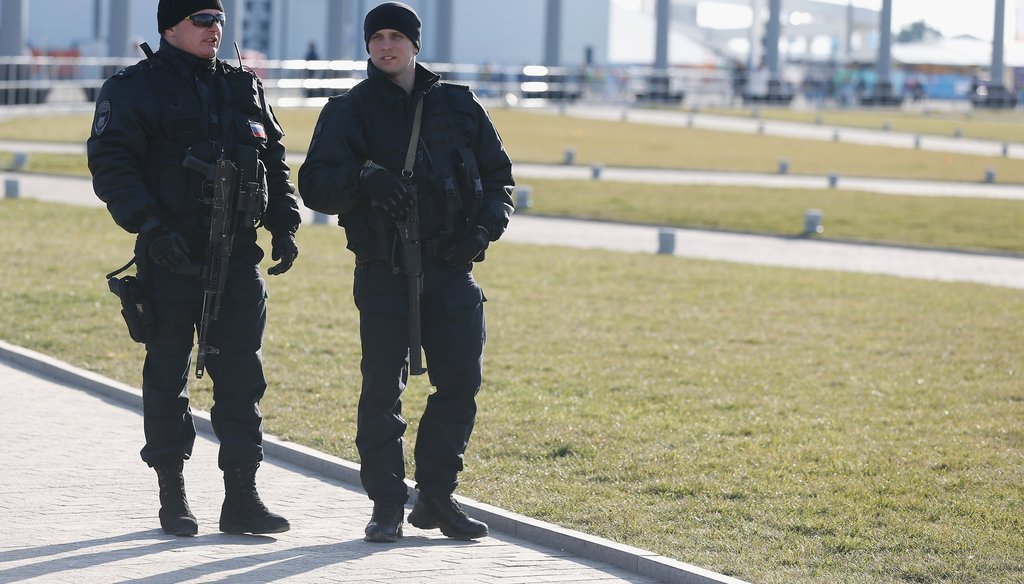 Security officers patrol Olympic Park before opening ceremonies in Sochi on Feb. 7. (Getty)