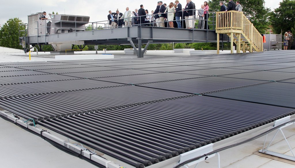 Guests look at one of the largest commercial rooftop solar arrays in the state from a viewing platform at DataScan Technologies in Alpharetta, Ga. Credit: Phil Skinner/AJC.