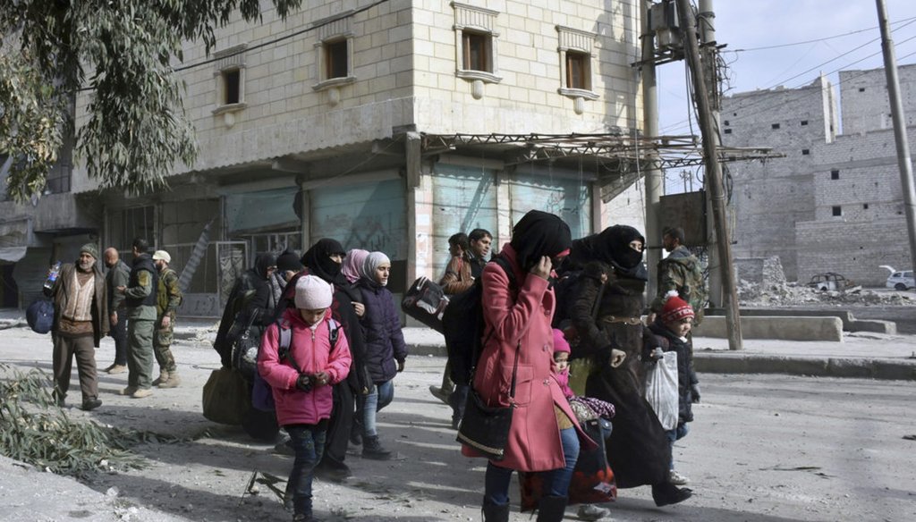 In this photo released by the Syrian official news agency SANA, residents flee east Aleppo in Syria as government forces push into rebel-held areas. (Associated Press)