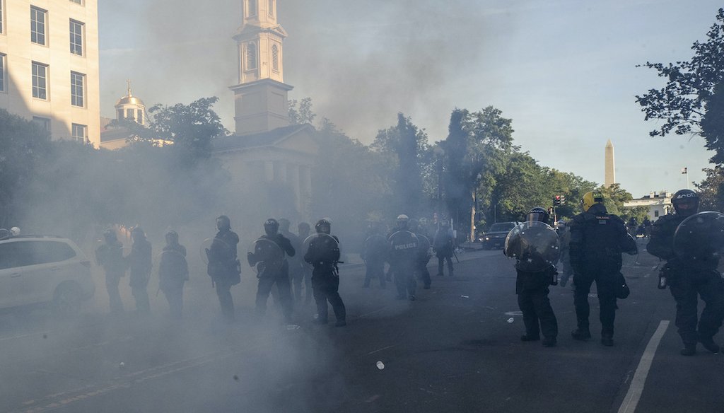 A line of police move demonstrators away from St. John's Church across Lafayette Park from the White House June 1. (AP Photo/Alex Brandon)