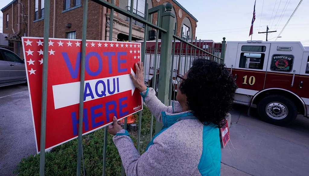Election worker Ramona Ortiz places a sign Nov. 8, 2022, outside an El Paso, Texas, a polling station. (AP)