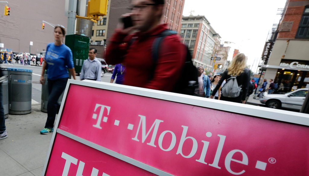 People pass a T-Mobile store in New York in 2015. (AP)