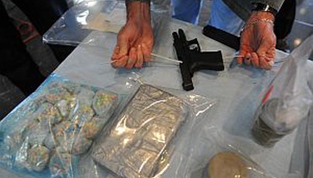 A handgun is displayed along with drugs seized in a raid in 2010. A Customs officer assigned to the Atlanta airport was arrested after taking payoffs to smuggle guns and drug money. Georgia is one of the highest ranking states for gun trafficking.
