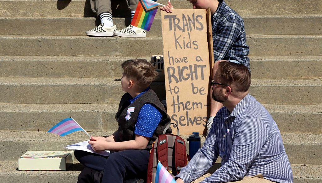 Niko Dittrich-Reed, left, and his father, Dylan Dittrich-Reed, right, attend a rally March 29, 2023., outside the South Carolina State House, in Columbia, S.C. (AP)