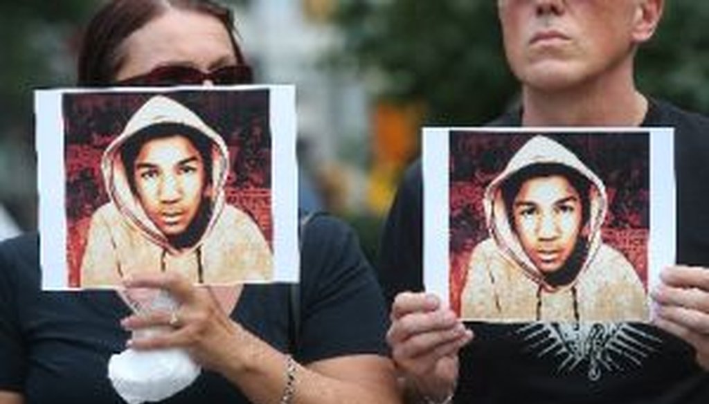 People hold photos of Trayvon Martin at a rally honoring Martin at Union Square in Manhattan on July 14, 2013 in New York City.