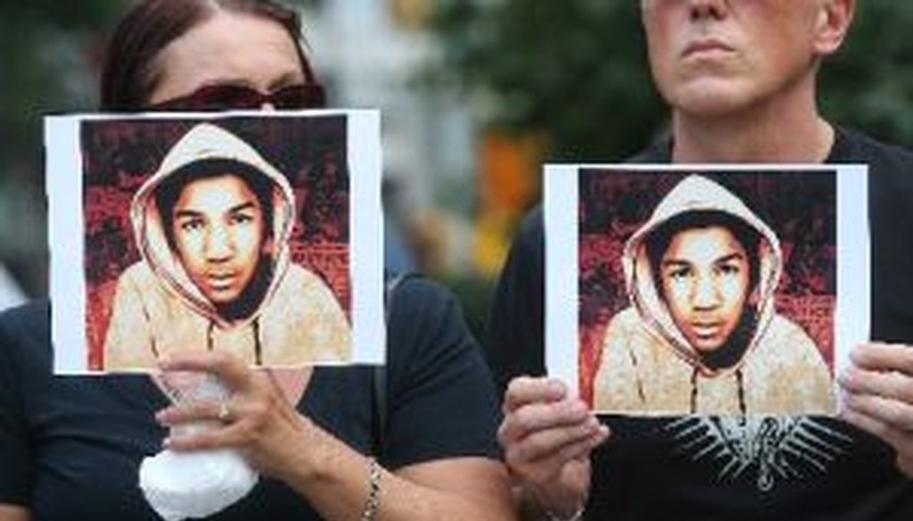 People hold photos of Trayvon Martin at a rally honoring Martin at Union Square in Manhattan on July 14, 2013 in New York City. 