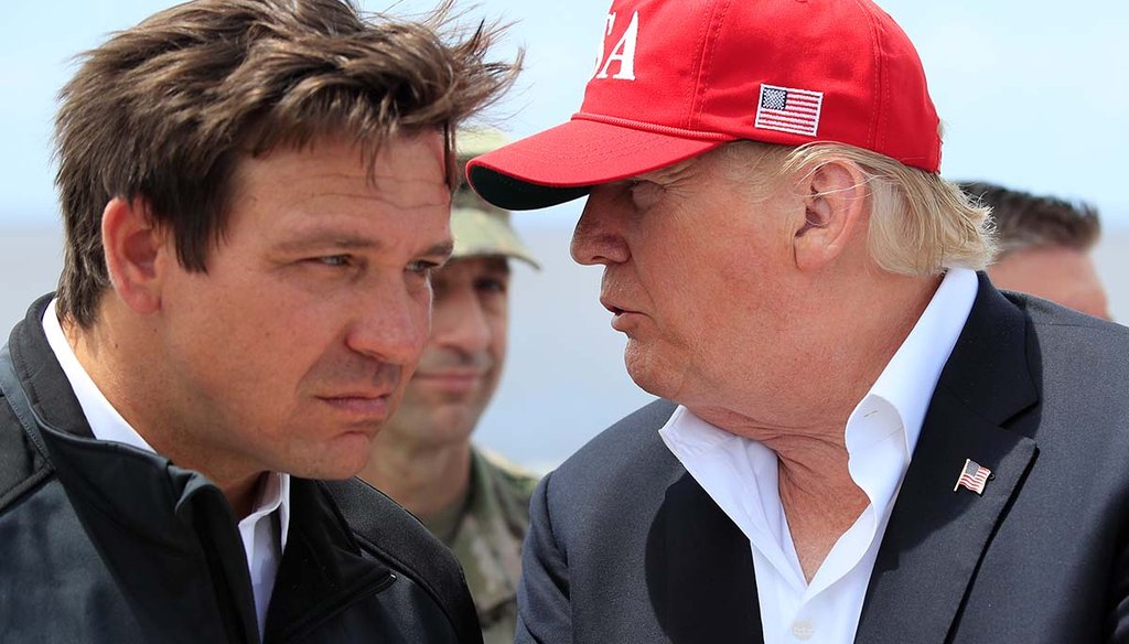 Former President Donald Trump talks to Florida Gov. Ron DeSantis, left, during a March 29, 2019, visit to Lake Okeechobee and Herbert Hoover Dike at Canal Point, Fla. (AP)