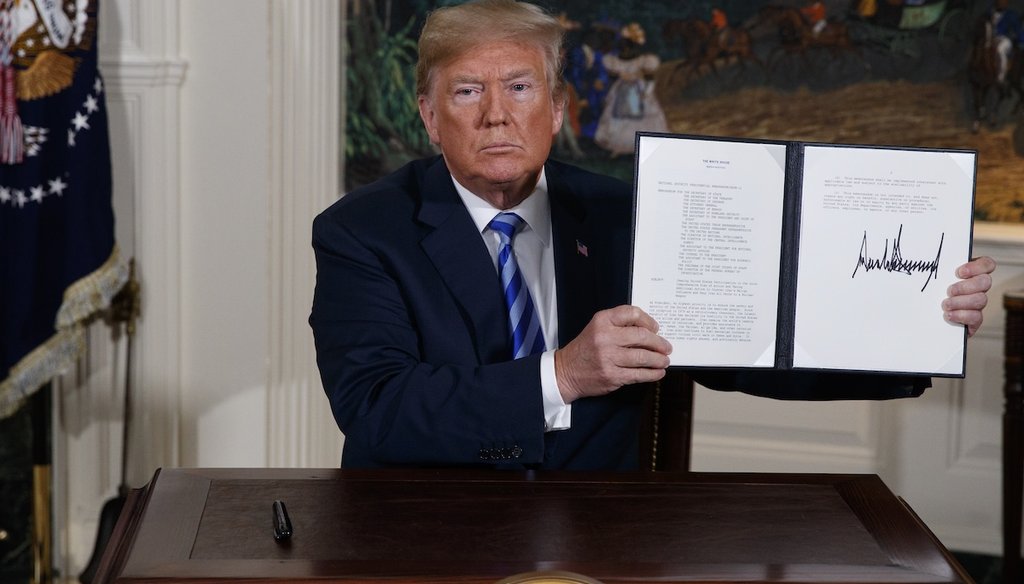 President Donald Trump shows a signed presidential memorandum after delivering a statement on the Iran nuclear deal from the White House on May 8, 2018. (AP)