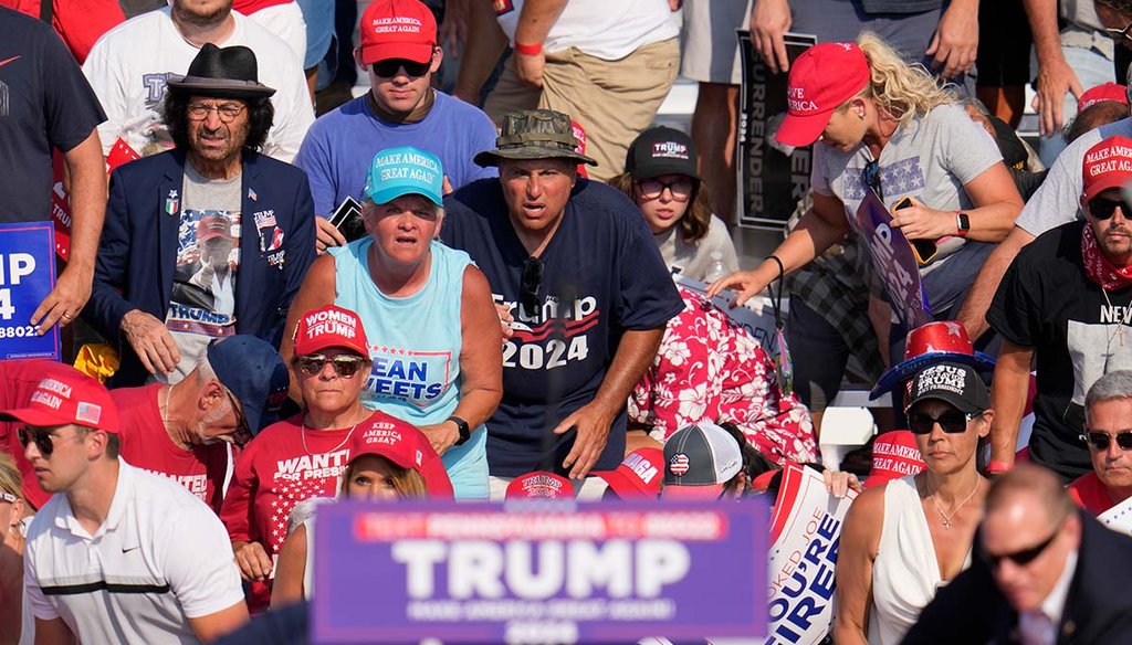 Rallygoers react after former President Donald Trump is shot at a rally July 13, 2024, in Butler, Pa. (AP)