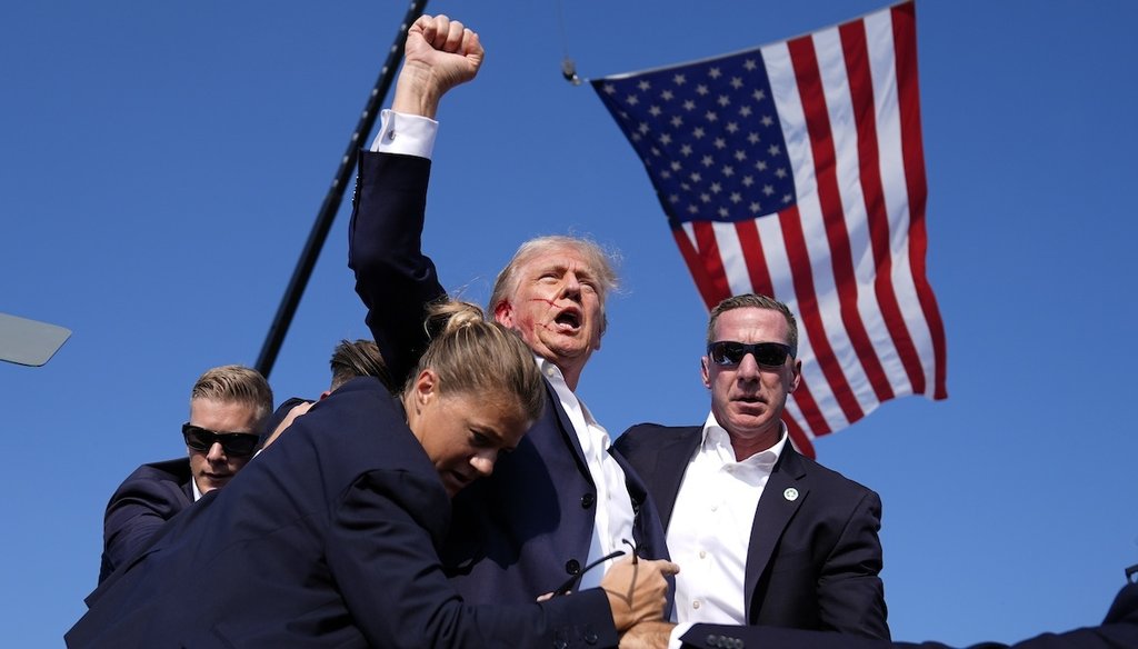 Republican presidential candidate former President Donald Trump is surrounded by U.S. Secret Service agents after an assassination attempt at a campaign rally in Butler, Pa., Saturday, July 13, 2024. (AP)