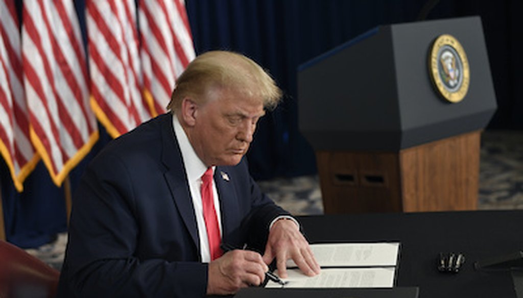 President Donald Trump signs one of four executive measures addressing the economic fallout from the COVID-19 pandemic on Aug. 8, 2020. (AP)