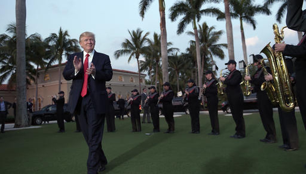 In this Feb. 5, 2017, file photo, U.S. President Donald Trump listens to the Palm Beach Central High School Band as they play at his arrival at Trump International Golf Club in West Palm Beach, Fla. (AP)