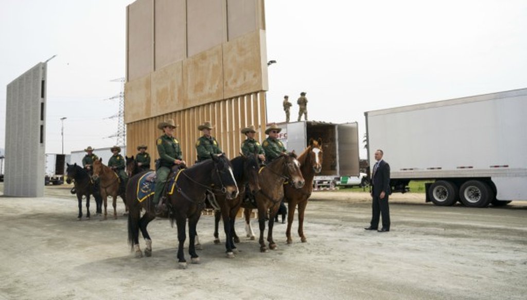 Horse-mounted Border Patrol agents as President Donald Trump views border wall prototypes in the border neighborhood of Otay Mesa near San Diego, March 13, 2018 (Doug Mills/The New York Times).