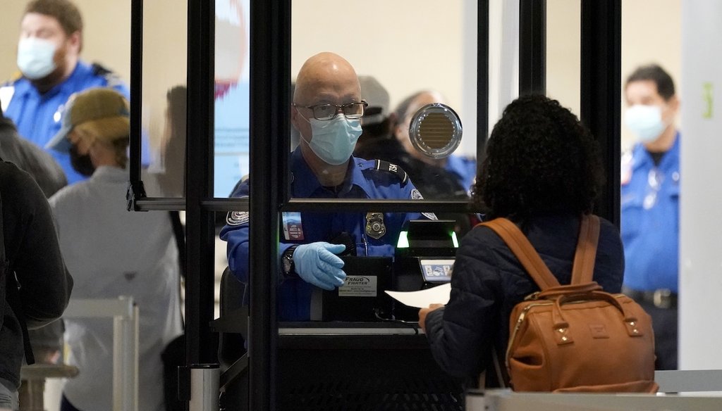 A Transportation Security Administration agent assists a traveler at a security checkpoint at Love Field Airport in Dallas in 2020. (AP)