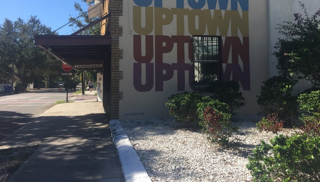 A sprawling geometric mural and a new insignia with the word “Uptown” can be seen on the sides of the building that houses the Uptown Laundromat. (Photo by Allison Graves)